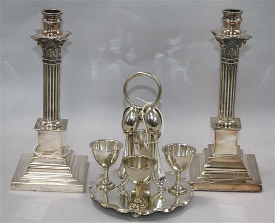 A pair of epns Corinthian column candlesticks and an egg stands
